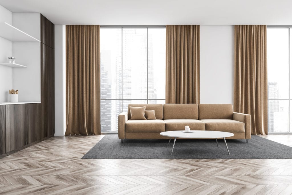 Wooden And Beige Kitchen Set With Sofa Near Window With Curtains