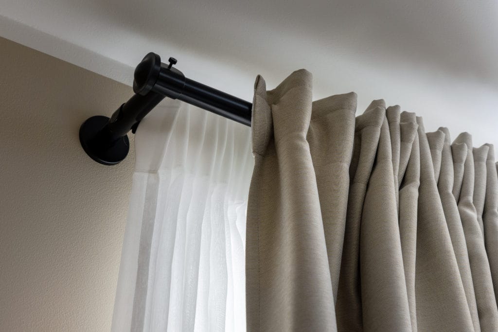 Double Layer Curtains On Black Rod In Living Room