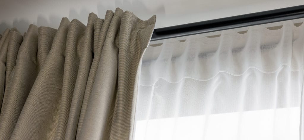 Double Layer Day And Night Curtains On Black Rod In Living Room